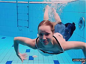 teen doll Avenna is swimming in the pool